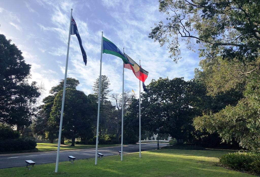 Aboriginal and Torres Strait Islander Flags fly alongside the Australian Flag at Government House